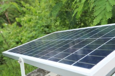 Solar panel outdoor with green tree background (Thailand),Alternative power in renewable resource,Energy concept,Save environment concept