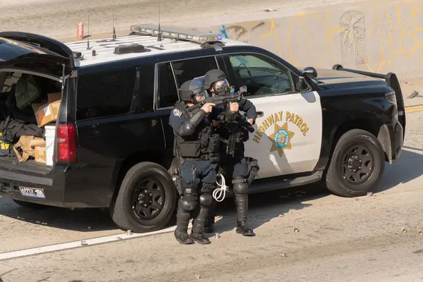 Los Angeles, ABD, 8 Haziran 2025 Çevik Kuvvet Polisi genişletilmiş ICE operasyonlarına ve göçmen haklarına karşı düzenlenen gösteride protestoculara plastik mermi tabancası doğrulttu.