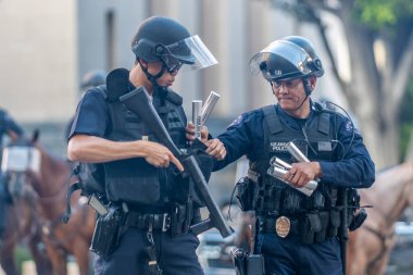 Los Angeles, ABD, 8 Haziran 2025 Polis memurları genişletilmiş göçmen haklarına karşı düzenlenen bir gösteride silahları yeniden yüklüyorlar.