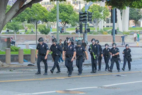 Los Angeles, ABD, 8 Haziran 2025: Polis memurları genişletilmiş ICE operasyonlarına ve göçmen haklarına karşı düzenlenen bir gösteride düzen içinde yürüyorlar