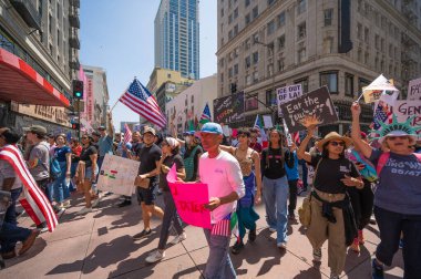 Los Angeles, Kaliforniya, ABD, 14 Temmuz 2025, Hükümetin politikalarını protesto eden ve demokrasi ve göçmen haklarını destekleyen protestocular ellerinde sloganlar tutuyorlar..