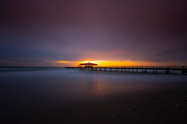 İskele ve kıyıda uzun pozlama tekniğiyle çekilmiş fantastik bir fotoğraf.