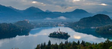 Aerial landscape photography. Colorful morning scene of Pilgrimage Church of the Assumption of Maria. Aerial autumn view of Bled lake, Julian Alps, Slovenia, Europe. Traveling concept background. clipart