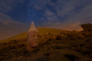View of mount Nemrut and monumental sculptures of commagene kings and gods with colorful clouds and sky