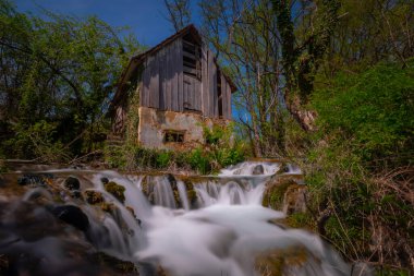 Old mill in the Una National Park. The Una River flows under the mill. Summer landscape in the National Park.