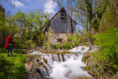 Old mill in the Una National Park. The Una River flows under the mill. Summer landscape in the National Park.