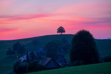 The beautiful village of Hirzel with green meadows and farmlands on the slopes, Canton of Zug, Switzerland, Europe.