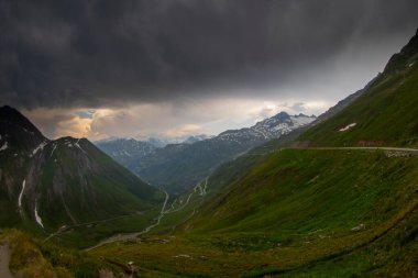 Furka Pass and Grimsel Pass in the swiss alps in early summer with still snow on the mountains