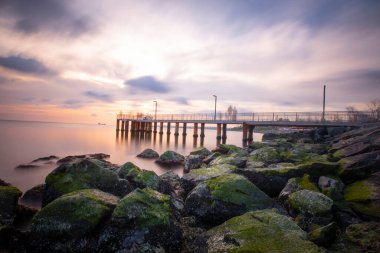 Sunset in Florya and people by sea side.