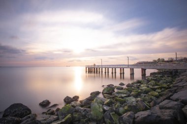 Sunset in Florya and people by sea side.