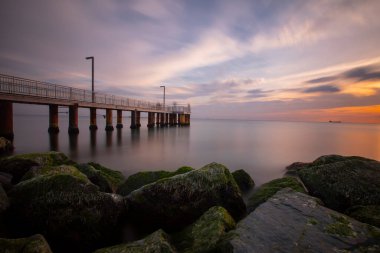 Sunset in Florya and people by sea side.