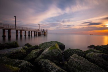Sunset in Florya and people by sea side.