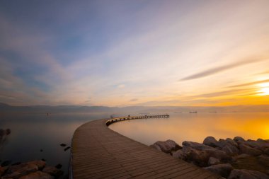 Boomerang shaped pier representing infinity photographed with long exposure technique