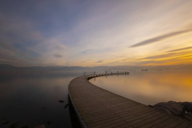 Boomerang shaped pier representing infinity photographed with long exposure technique