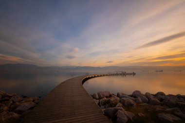 Boomerang shaped pier representing infinity photographed with long exposure technique