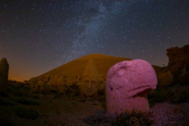 Ancient statues on the Nemrut mountain on the beautiful. Milky way galaxy. Unesco heritage. Nemrut, Turkey. Night landscape.