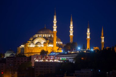 Suleymaniye Mosque with night illumination and minaret of Rustem Pasha Mosque, Istanbul, Turkey