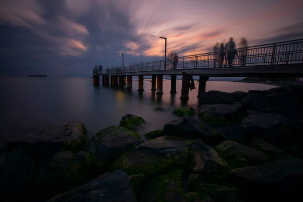 The aesthetic pier by the sea was photographed with the long exposure technique.