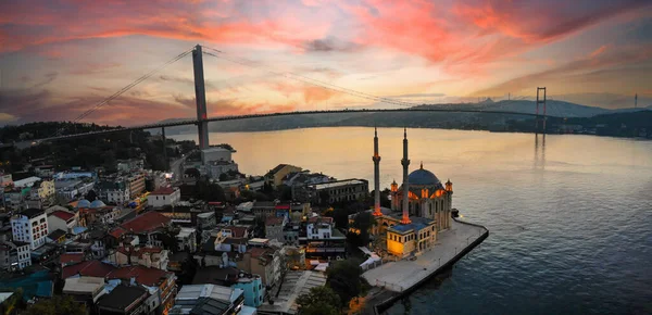 stock image Aerial view of Ortakoy mosque, also known as Buyuk Mecidiye, backgrounded by 15 July Martyrs bridge and Bosphorus strait in Besiktas district, Istanbul, Turkey.