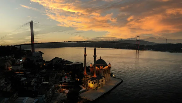 stock image Aerial view of Ortakoy mosque, also known as Buyuk Mecidiye, backgrounded by 15 July Martyrs bridge and Bosphorus strait in Besiktas district, Istanbul, Turkey.