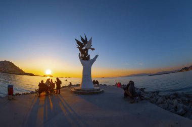 Hand of peace sculpture with doves on the waterfront in Kusadasi.