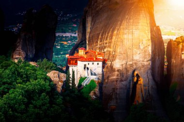 Meteora Varlaam Monastery rising out of the mist. Amazing mystical landscape. A UNESCO heritage site. Meteora mountains, Thessaly, Greece. clipart