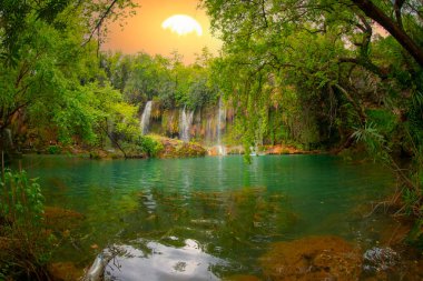 Beautiful waterfalls over emerald water in deep green forest in Kursunlu Natural Park, Antalya, Turkey