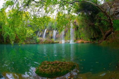 Beautiful waterfalls over emerald water in deep green forest in Kursunlu Natural Park, Antalya, Turkey