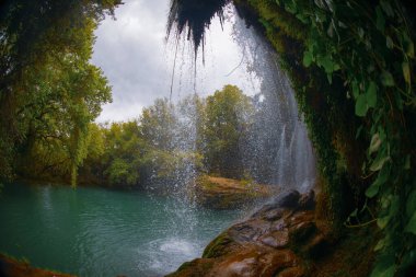 Beautiful waterfalls over emerald water in deep green forest in Kursunlu Natural Park, Antalya, Turkey