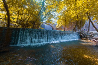 The old stone, arched bridge, between two waterfalls in Palaiokaria, Trikala prefecture, Thessaly, Greece.