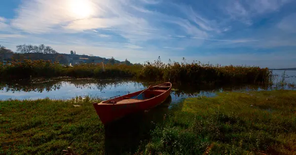 stock image Balkesir Lake Manyas at sunset boats reflection vegetation cloudy sky