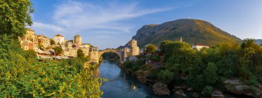 Stari Most bridge at twilight in old town of Mostar, Bosnia and Herzegovina. Mostar cityscape at summer clipart