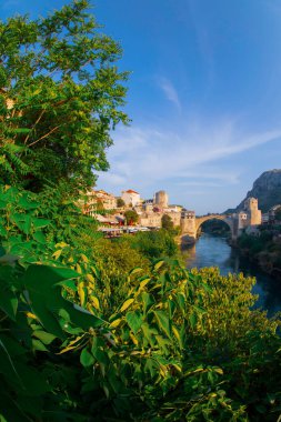 Stari Most bridge at twilight in old town of Mostar, Bosnia and Herzegovina. Mostar cityscape at summer clipart