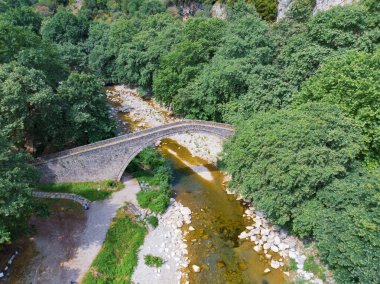 Eski taş, kemerli köprü, Palaiokaria, Trikala vilayeti, Thessaly, Yunanistan 'daki iki şelale arasında.