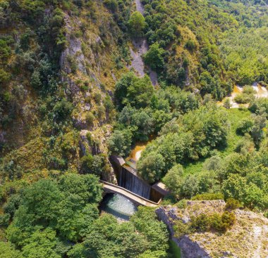 The old stone, arched bridge, between two waterfalls in Palaiokaria, Trikala prefecture, Thessaly, Greece.