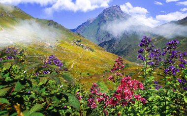 Lakes formed when the snow melted in a spring weather with white clouds in the blue sky. Lakes formed at the summit. Kackar Mountains. Verenik clipart