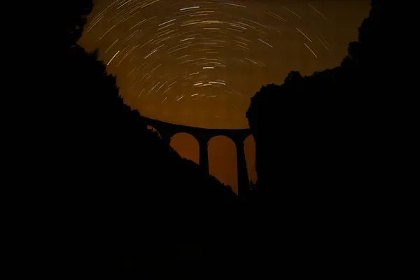 stock image Swiss red train on viaduct in mountain, scenic ride