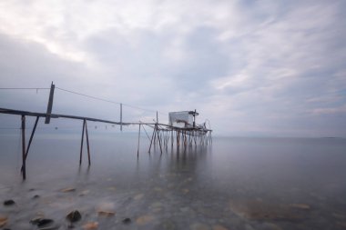 Fishing shelters located in the middle of the sea. clipart