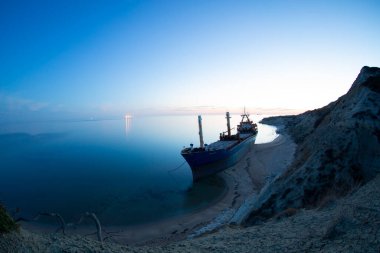 A large ship washed ashore in Bozcaada, Canakkale clipart