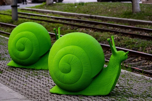 stock image On June 16, 2023, in Changchun, China, a group of green snail arts was exhibited at Route 54 Tram Station. These snails come from Italy, adding a beautiful landscape to Changchun's summer.