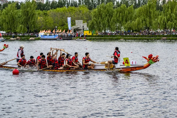 stock image On June 22, 2023, Changchun, Jilin, the first Dragon Boat Invitational Tournament was held on the banks of the Yitong River in Changchun. There are various water performances on the river.
