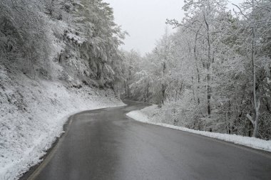 Mountain road in winter, Tanaro valley, Piedmont, Ligurian Alps, Italy clipart