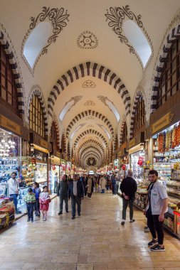 İstanbul, Türkiye - 11 Kasım 2024: İstanbul 'da Eminonu Meydanı' ndaki Mısır Pazarı olarak da bilinen Baharat Çarşısı 'nın tarihi simgesine bir insan ve turist kalabalığıyla birlikte bir bakış