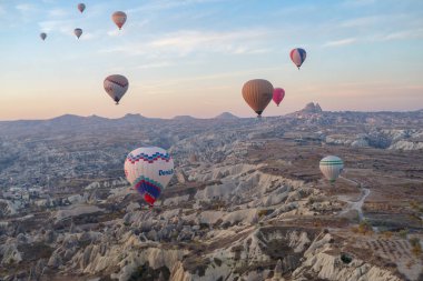 Goreme, Türkiye - 13 Kasım 2024: Goreme Ulusal Parkı, Kapadokya, Türkiye 'de karada uçan renkli sıcak hava balonları