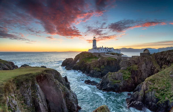アイルランドのドニゴール州ファナド郡長の灯台の上の日の出 ロイヤリティフリーのストック画像