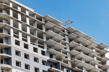 Rising from Blueprints: A Fascinating Glimpse of an Unfinished Building, Where Steel Meets Sky in the Dance of Architectural Development. clipart