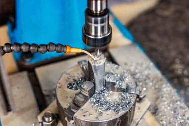 Precision in Progress A milling machine etches metal with a mist of coolant, showcasing the perfect balance of innovation and engineering craftsmanship in action. clipart