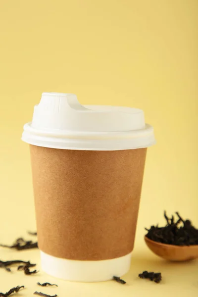 Disposable takeaway cups with tea on beige background, including clipping path. Space for text. Top view