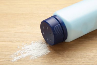 Baby powder on light background. Baby cosmetics. Top view