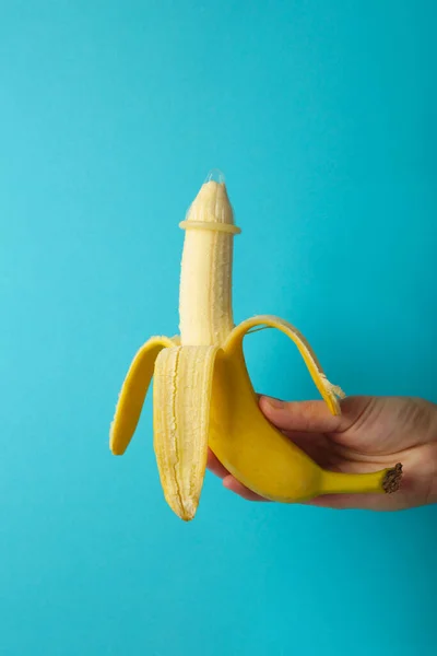Mano Femenina Sosteniendo Condón Plátano Concepto Sexo Seguro Sobre Fondo —  Fotos de Stock
